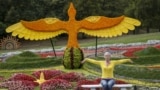 FILE - A woman poses for a picture at a flower exhibition in Kyiv, Ukraine, August 21, 2015. (REUTERS/Gleb Garanich)