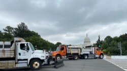 Dozens of dump trucks have been rolled out to form a security barrier ahead of a rally by supporters of former President Donald Trump at the U.S. Capitol, on Capitol Hill in Washington, Sept. 18, 2021. (Carolyn Presutti/VOA)