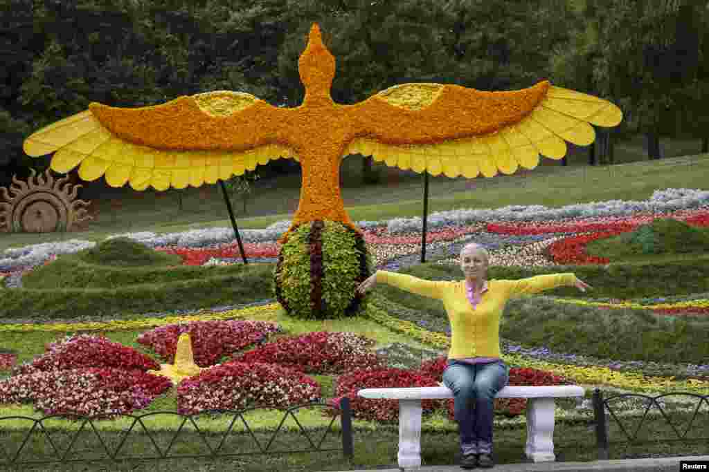 A visitor poses for a picture at a flower exhibition in Kyiv, Ukraine.