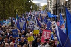 Brexit opponents take part in a "People's Vote" protest march calling for another referendum on Britain's EU membership, in London, Oct. 19, 2019.