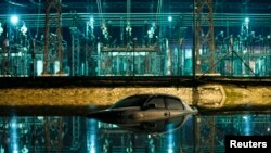 A car is submerged in Sungai Isap river in Kuantan, about 186 miles outside Kuala Lumpur, Dec. 6, 2013.
