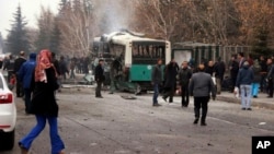 A destroyed public bus is seen at the scene of a car bomb attack in the central Anatolian city of Kayseri, Turkey, Dec. 17, 2016. 