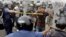 Police officials wield bamboo sticks to stop main opposition Bangladesh Nationalist Party activist during a protest in Kachpur, on the outskirts of Dhaka, December 9, 2012.