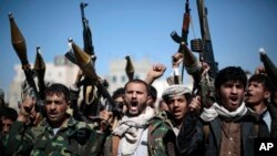 FILE - Tribesmen loyal to Houthi rebels hold their weapons as they chant slogans during a gathering to mobilize more fighters into battlefronts in several Yemeni cities, in Sana'a, Yemen, Nov. 24, 2016.