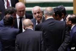 Palestinian Ambassador to the United Nations Riyad Mansour, center, talks with members of the General Assembly prior to a vote, Thursday, Dec. 21, 2017