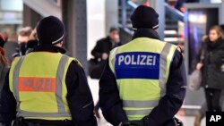 FILE - Police patrol in the main train station in Cologne, Germany, Jan. 18, 2016. Two men who were detained in Germany on suspicion of having links with Islamic State were released.