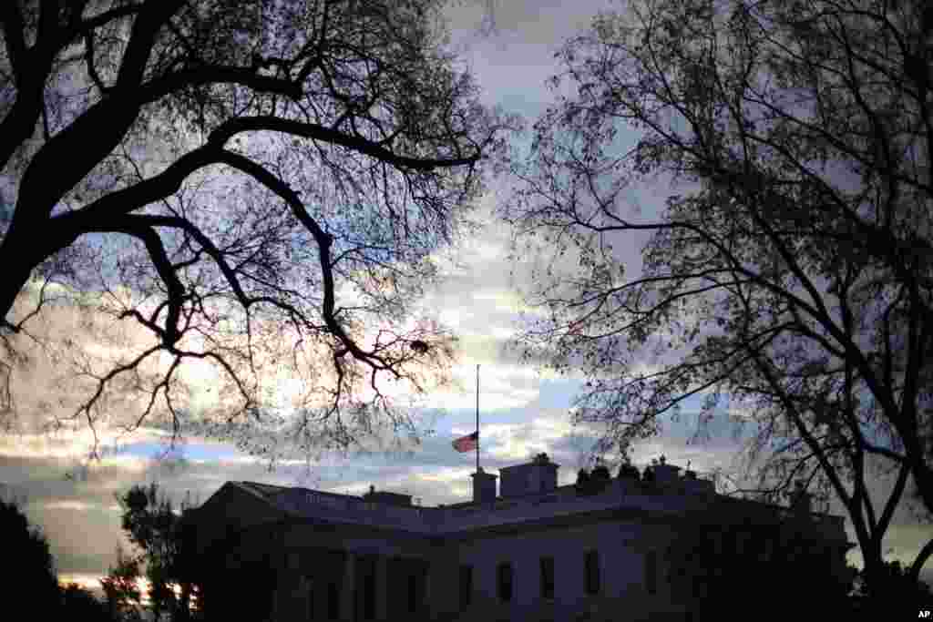 A flag flies at half-staff above the White House in Washington, early morning, Nov. 22, 2013. President Barack Obama ordered that flags be lowered at government buildings to mark the 50th anniversary of President John F. Kennedy&#39;s assassination. 