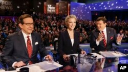 FILE - From left, FOX News debate moderators Chris Wallace, Megyn Kelly and Bret Baier wait for the start of the Republican presidential primary debate in Des Moines, Iowa, Jan. 28, 2016.