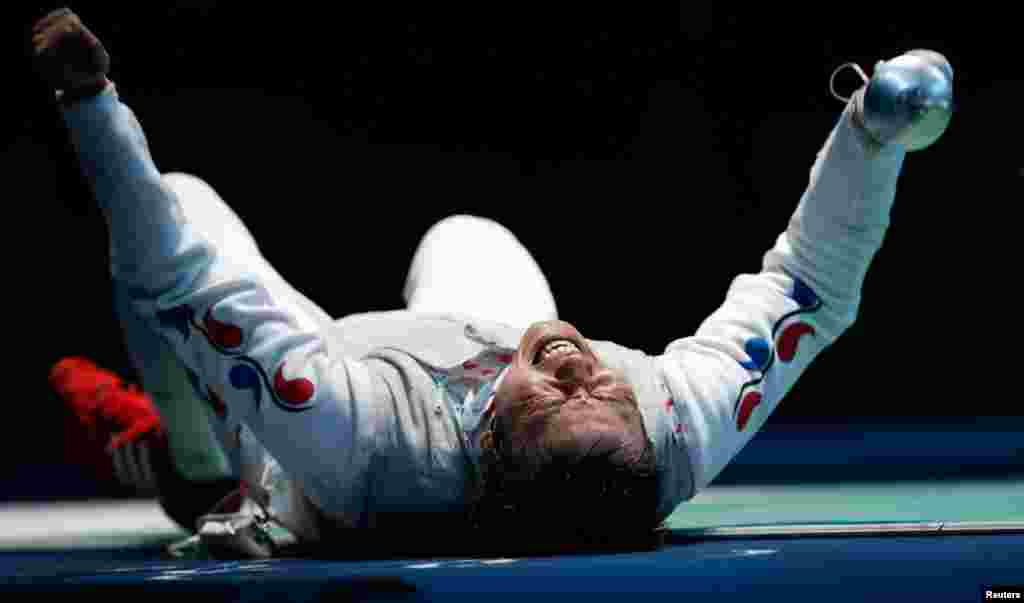 South Korea's Choi Byungchul celebrates defeating China's Ma Jinfei during their men's individual foil quarterfinal fencing competition.