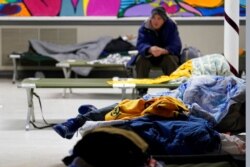 People seeking shelter from sup-freezing temperatures rest at a makeshift warming shelter at Travis Park Methodist Church, in San Antonio, Feb. 16, 2021.