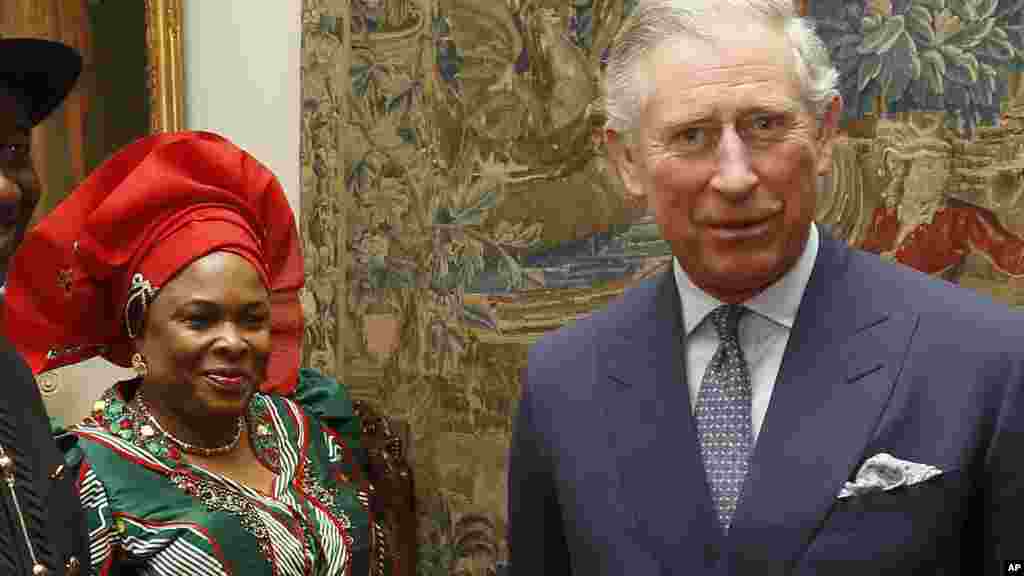 Britain's Prince Charles poses with First Lady Patience Johnathan at Clarence House in London February, 2012.