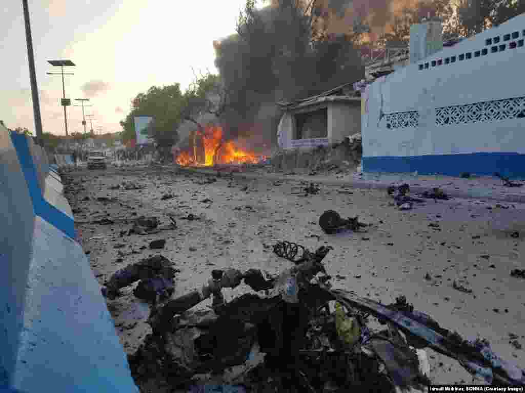Debris litters a Mogadishu street after a car bomb exploded next to a restaurant in the Somali capital, killing eight people and injuring 15.
