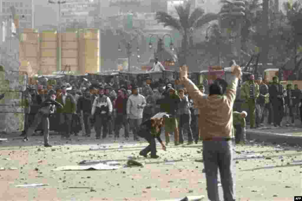 Supporters of President Hosni Mubarak, clash with anti-Mubarak protesters in Tahrir Square, Cairo, Egypt, Wednesday, Feb.2, 2011. Several thousand supporters of President Hosni Mubarak, including some riding horses and camels and wielding whips, clashed w