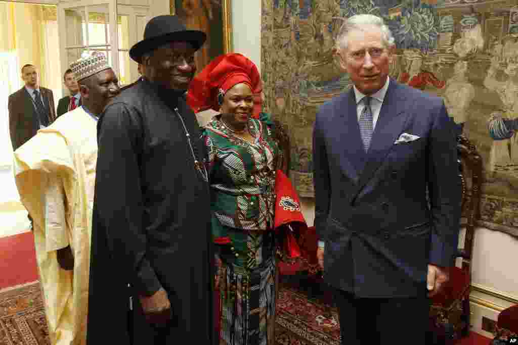 Britain's Prince Charles poses with First Lady Patience Johnson at Clarence House in London February, 2012.