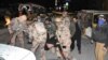 Soldiers carry a victim of a blast targeting a police truck in Quetta, Pakistan, Jan. 9, 2018. 