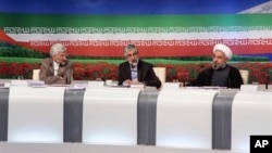 Presidential candidates from left: Saeed Jalili, Iran's top nuclear negotiator, Gholam Ali Haddad Adel, parliament lawmaker, and Hasan Rowhani, former top nuclear negotiator, attend TV debate, Tehran, June 7, 2013.