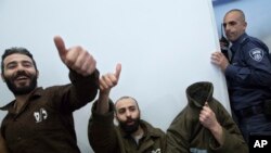 French consulate worker Romain Franck, a French employee of France's Consulate in Jerusalem, covers his face during a hearing at the district court in in the southern Israeli city of Beersheba, Monday, March 19, 2018.