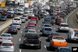 FILE - Southbound traffic on Interstate 5 moves through Los Angeles.