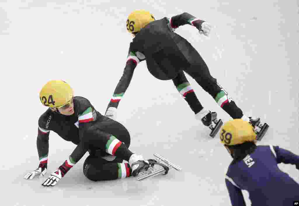 Arianna Fontana of Italy, left, crashes out in the women's 3000m short track speedskating relay final at the Iceberg Skating Palace during the 2014 Winter Olympics, Feb. 18, 2014.