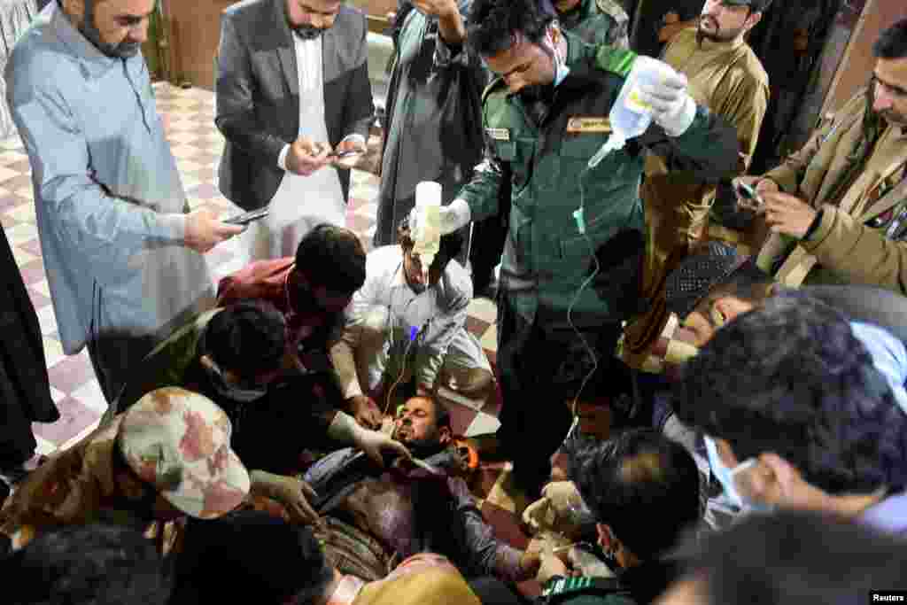 A passenger, who was rescued from a train after it was attacked by separatist militants, receives medical aid at the Mach Railway Station in Mach, Balochistan, Pakistan, March 11, 2025. 