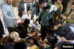 A passenger, who was rescued from a train after it was attacked by separatist militants, receives medical aid at the Mach Railway Station in Mach, Balochistan, Pakistan, March 11, 2025.