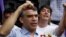 FILE - Peruvian presidential candidate Julio Guzman greets supporters during a rally at a market in the San Juan de Lurigancho district of Lima, Jan. 20, 2016.