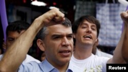 FILE - Peruvian presidential candidate Julio Guzman greets supporters during a rally at a market in the San Juan de Lurigancho district of Lima, Jan. 20, 2016.