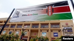 FILE - A banner promoting peace hangs outside the Westgate shopping mall during the first anniversary memorial service of the Westgate terrorist attack in Kenya's capital Nairobi, Sept. 21, 2014. 