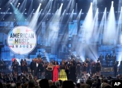 Tracee Ellis Ross, center, speaks at the conclusion of the American Music Awards following a tribute to the late singer Aretha Franklin, Oct. 9, 2018, at the Microsoft Theater in Los Angeles.
