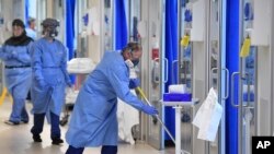 Members of the clinical staff wearing on Personal Protective Equipment PPE clean the intensive care unit at the Royal Papworth Hospital in Cambridge, England, May 5, 2020.