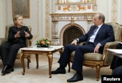 FILE - U.S. Secretary of State Hilary Clinton, left, and Russian Prime Minister Vladimir Putin meet at the presidential residence Novo-Ogaryovo outside Moscow, March 19, 2010.