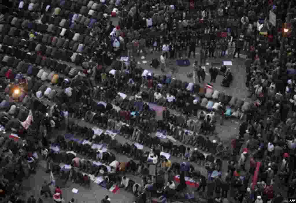 Anti-government protesters pray, as others demonstrate in Tahrir, or Liberation Square in Cairo, Egypt, Tuesday, Feb. 1, 2011. More than a quarter-million people flooded into the heart of Cairo Tuesday, filling the city's main square in by far the largest