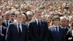 Raja Felipe dari Spanyol, tengah, PM Mariano Rajoy, kiri tengah, dan Presiden kawasan Catalonia, Carles Puigdemont, kanan tengah bergabung dengan warga untuk mengheningkan cipta untuk mengenang serangan teroris di Las Ramblas, Barcelona, Spanyol, 18 Agustus 2017 (foto: AP Photo/Manu Fernandez)