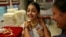 Girl tries on gold necklace inside a jewelry showroom in Mumbai, April 16, 2013.