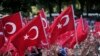 FILE - Pro-government demonstrators wave Turkish flags as they rally against the attempted coup in Istanbul, Turkey, July 19, 2016. The Turkish government accelerated its crackdown on alleged plotters of the failed coup against President Recep Tayyip Erdogan.
