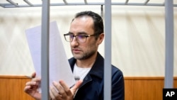 FILE - Eugene Spector, Russian-born U.S. citizen already imprisoned in Russia on a bribery stands behind bars in a courtroom in Moscow, Russia, Feb. 20, 2020. Spector has been handed a second 15-year jail term for espionage, Russian news agencies reported on Dec. 24, 2024.