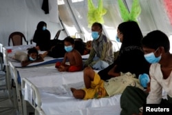FILE - Rohingya refugees, who suffer from diphtheria, are treated at a Medecins Sans Frontieres (MSF) clinic near Cox's Bazar, Bangladesh, Dec. 18, 2017.