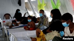 FILE - Rohingya refugees, who suffer from diphtheria, are treated at a Medecins Sans Frontieres (MSF) clinic near Cox's Bazar, Bangladesh, Dec. 18, 2017.