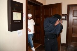 FILE - Members of the entourage of US rapper Rakim Mayers, known by his stage name Asap Rocky, leave a courtroom after a hearing in his trial over a street brawl on July 5, 2019 in Stockholm.