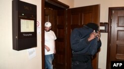 FILE - Members of the entourage of US rapper Rakim Mayers, known by his stage name Asap Rocky, leave a courtroom after a hearing in his trial over a street brawl on July 5, 2019 in Stockholm. 