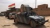 Iraqi security forces are seen on patrol after pushing Islamic State militants out of Fallujah, Iraq, June 26, 2016.