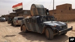Lực lượng an ninh Iraq tuần tra sau khi đẩy lui chiến binh Hồi giáo Nhà nước ra khỏi Fallujah, ngày 26/6/2016.