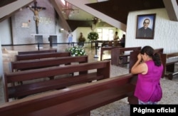 Cecilia Flores prays inside the chapel where Archbishop Oscar Arnulfo Romero was assassinated in1980, in San Salvador, El Salvador, Oct. 5, 2018.