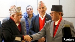 FILE - Chairman of Communist Party of Nepal (Unified Marxist-Leninist) (CPN-UML) party Khadga Prasad Sharma Oli, also known as K.P. Oli, (L) shakes hands with the chairman of Communist Party of Nepal (Maoist Centre) Pushpa Kamal Dahal, also known as Prachanda, during a news conference in Kathmandu, Dec. 17, 2017. 