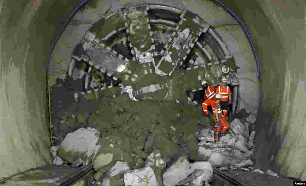 Crossrail workers climb out from &quot;Victoria&quot;, a tunnel boring machine after breaking through at Whitechapel underground station in London. Crossrail is the largest infrastructure project in Europe and will provide a new link across London which is due to be completed in 2017.