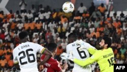 Egypt's goalkeeper #16 Mohamed el Shenawy makes a save during the Africa Cup of Nations (CAN) 2024 group B football match between Egypt and Ghana at the Felix Houphouet-Boigny Stadium in Abidjan on January 18, 2024. (Photo by Issouf SANOGO / AFP)