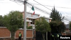 Police officers stand guard next to Mexico's embassy in La Paz, Bolivia Dec. 26, 2019. 