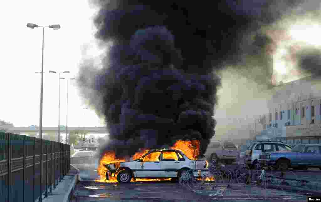 Anti-government protesters set a car on fire to create a road block to mark the second anniversary of the February 14 uprising, in Budaiya, west of Manama, Bahrain Feb. 14, 2013.