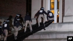 Using a tactical vehicle, New York City police enter an upper floor of Hamilton Hall on the Columbia University campus in New York April 30, 2024, after a building was taken over by protesters earlier Tuesday.