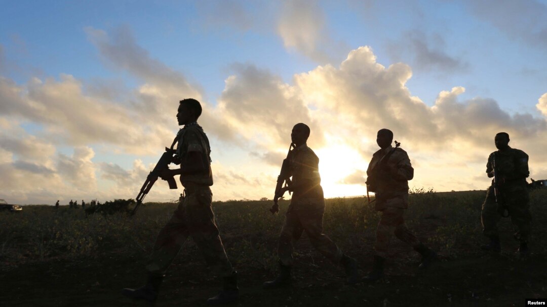FILE - Somali army soldiers are seen near Barawe, Somalia, Oct. 4, 2014.